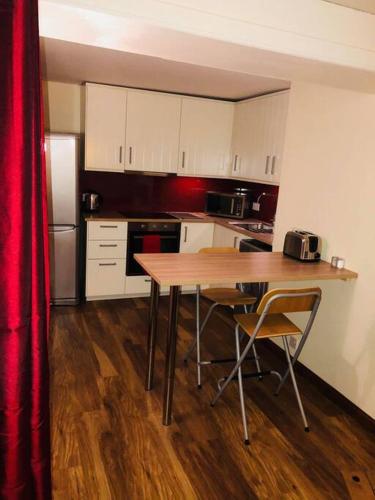a kitchen with a table and chairs in a room at Vibrant Apartment at The Shore in Leith in Edinburgh