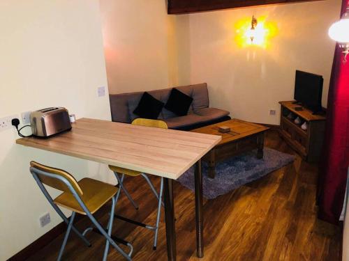 a living room with a table and a couch at Vibrant Apartment at The Shore in Leith in Edinburgh