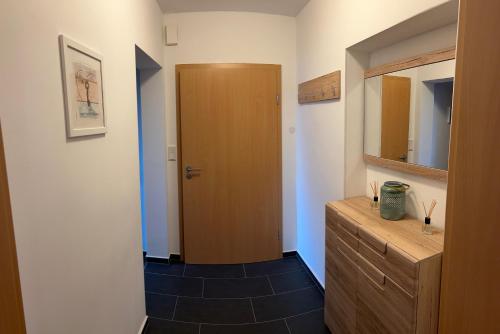 a bathroom with a wooden cabinet and a wooden door at Ferienwohnung Lucky Soest in Soest