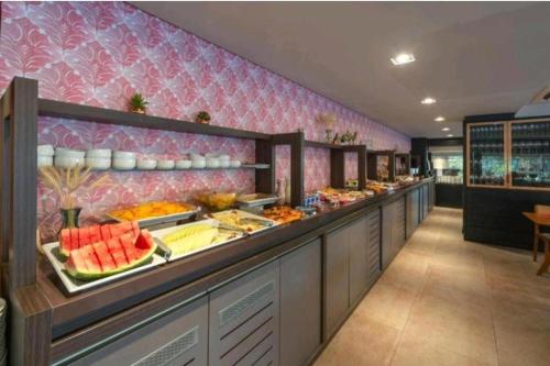 una línea de buffet con mucha comida en exhibición en Suite 304B no Hotel Laghetto Stilo Borges en Gramado