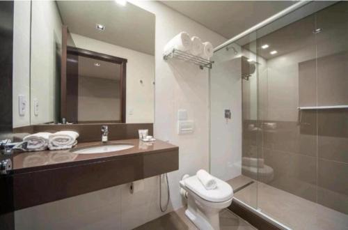 y baño con aseo, lavabo y ducha. en Suite 304B no Hotel Laghetto Stilo Borges en Gramado