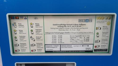 a sign with a menu on a blue wall at Apartment Una - Self check in in Graz