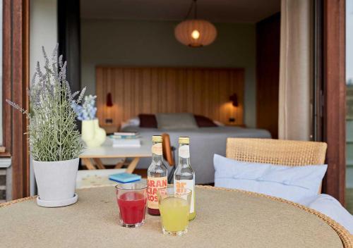 a table with two bottles and two glasses on it at Charlottehaven in Copenhagen