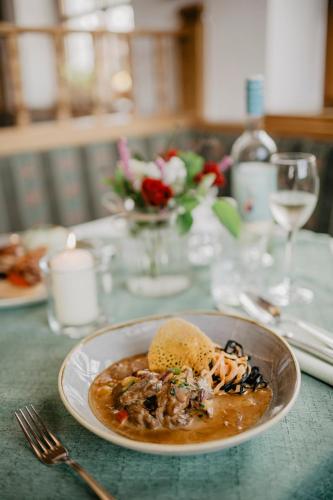 a plate of food on a table with a plate of food at Weßner Hof Landhotel & Restaurant in Marquartstein