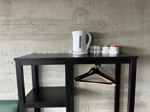 a black table with a cup on top of it at Brú Country Estate in Selfoss