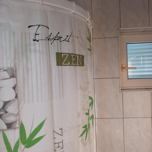 a shower with a shower curtain in a bathroom at Apartman Selce in Selce