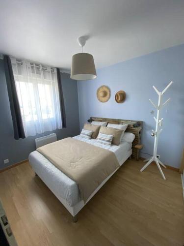 une chambre avec un grand lit dans une pièce dans l'établissement L’atelier du Bois de Charbuy, à Charbuy