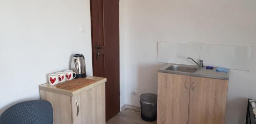 a small kitchen with a sink and a counter at Pokoje in Tczew