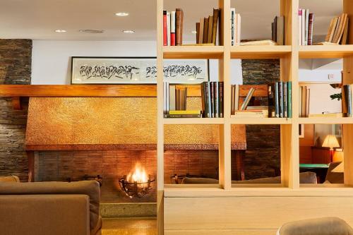 a fireplace in a living room with a fire place at Hotel de l'Isard in Andorra la Vella