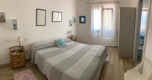 Postel nebo postele na pokoji v ubytování Punta Sirenella