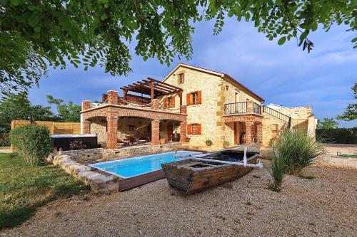 a house with a swimming pool in front of it at Villa Gland in Nin