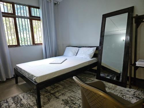 Giường trong phòng chung tại Kamili Homes Apartment 1