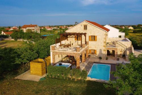 an aerial view of a house with a swimming pool at Villa Gland in Nin