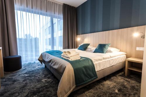 Postel nebo postele na pokoji v ubytování Hotel Zatoka