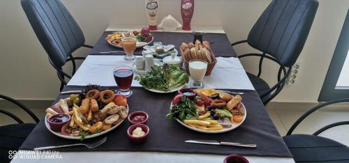 a table with plates of food and drinks on it at JK Business in Denizli