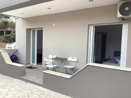 a patio with a table and chairs on a balcony at MARMARI apartments in Ayía Marína