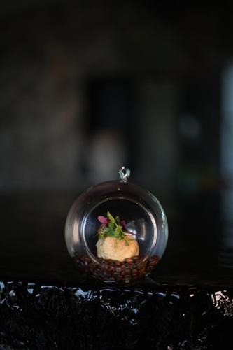 a small glass dish with a plant in it at Radisson Resort and Spa Lonavala in Lonavala