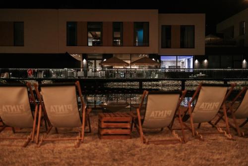 a group of chairs sitting on the beach at night at VISLOW Resort in Wisła