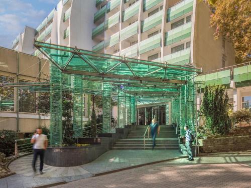 people standing in front of a building at Hotel Carbona Thermal Spa in Hévíz