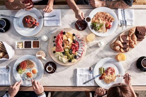 a group of people sitting around a table with food at Life Gallery Athens in Athens