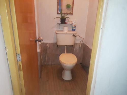 a small bathroom with a toilet and a sink at SUPER SUN HOMESTAY in Katugastota