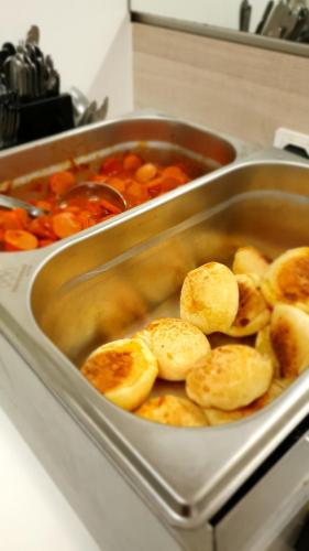 a pan filled with food in a stove top at Hotel Bella Júlia in Joinville