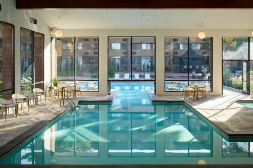 a large swimming pool in a building with windows at Sheraton Grand Rapids Airport Hotel in Grand Rapids