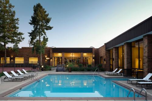 a swimming pool in front of a building at Sheraton Grand Rapids Airport Hotel in Grand Rapids