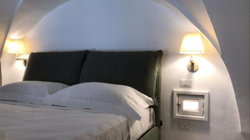 a bedroom with a bed and a lamp on a wall at Dimora San Felice Il Fico in Gallipoli