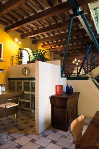 a restaurant with a fireplace and a table and chairs at Spazio seicentesco in Fossombrone