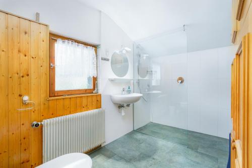 a bathroom with a sink and a toilet and a shower at Chalet Levi by Alpine Host Helpers in Kirchberg in Tirol