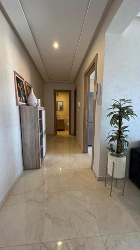 a hallway with a potted plant in a room at Haut Standing Appartement - Centre Ville Oujda in Oujda