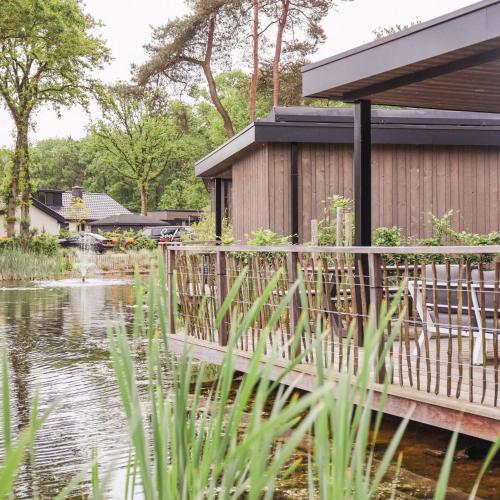 a house with a deck over a pond at Soof Heuvelrug in Rhenen