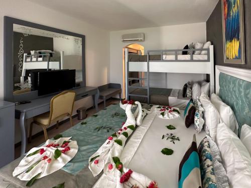 a bedroom with a bunk bed and a desk at Tiana Beach Resort in Turgutreis