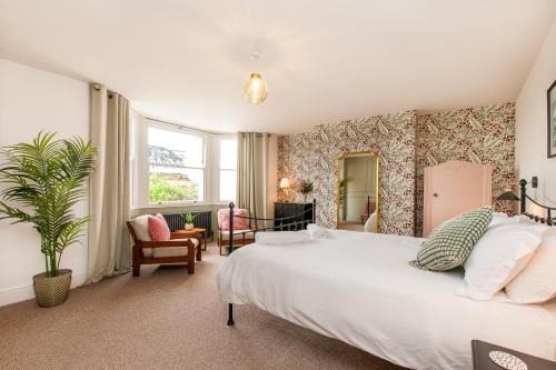 a bedroom with a large white bed in a room at King Palm Apartment at Sea View Terrace, Margate. in Kent