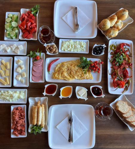 a wooden table with plates of food on it at Grand Uchisar Hotel in Uchisar