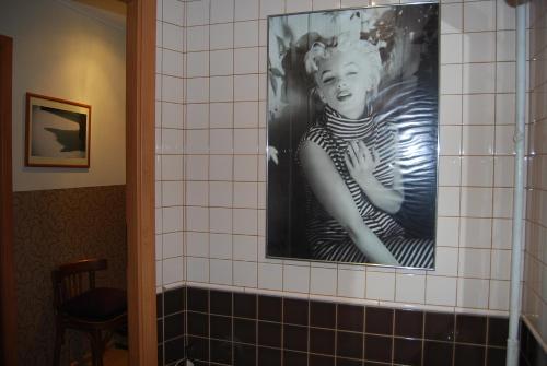a picture of a woman on the wall of a bathroom at Apartment Stepana Bandery Street in Rivne