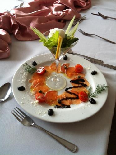 a plate of food with a drink on a table at Zajazd Pasja in Sławków