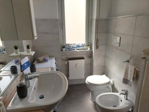 a bathroom with a white sink and a toilet at House Mamma Marisa by Holiday World in Genoa