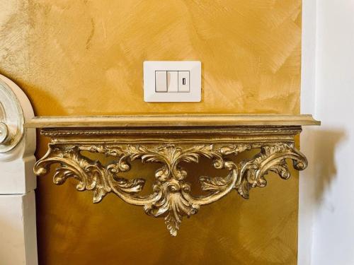 a lightswitch on top of a gold wall at Casa belvedere luxury in Anzio