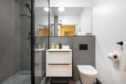 a bathroom with a toilet and a shower at Calvin Street converted warehouse in London