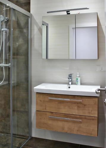 a bathroom with a sink and a shower at Landhaus Seppenbauer in Bad Ischl