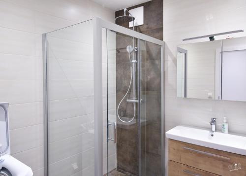 a bathroom with a shower and a sink at Landhaus Seppenbauer in Bad Ischl