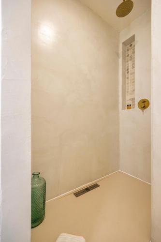 a white room with a vase on the floor at l'Alcove - SPA&SAUNA privé - Oliveraie d'Eurocentre in Castelnau-dʼEstrétefonds
