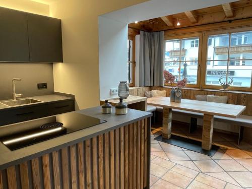 a kitchen with a sink and a counter top at Appartements Lorenzoni, Cafe Konditorei Helmut Lorenzoni in Kirchberg in Tirol