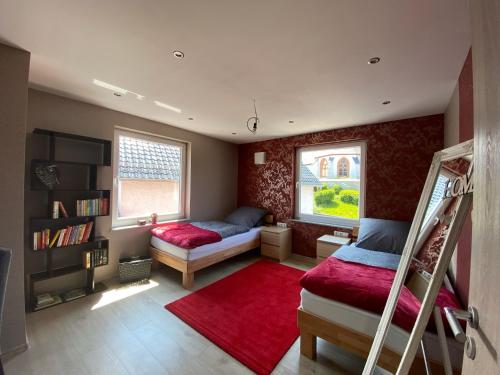a bedroom with two bunk beds and a red rug at Haus Lotusblüte in Kelberg