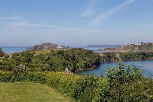 a view of a river with a hill in the distance at Island View at White Horses, Bantham, South Devon - with glorious sea views in Bantham
