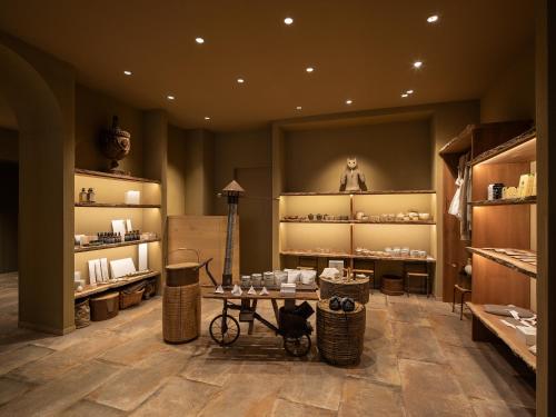 a store with a table and baskets in a room at moksa in Kyoto