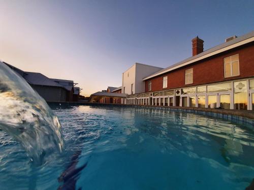 a large pool of water in front of a building at Protea Hotel by Marriott Kimberley in Kimberley