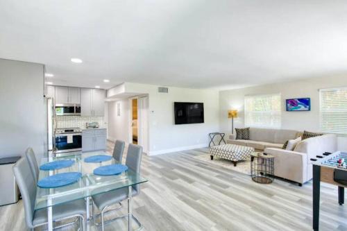a living room with a table and a couch at Dog friendly condo with beach access, hot tub, firepit in West Palm Beach